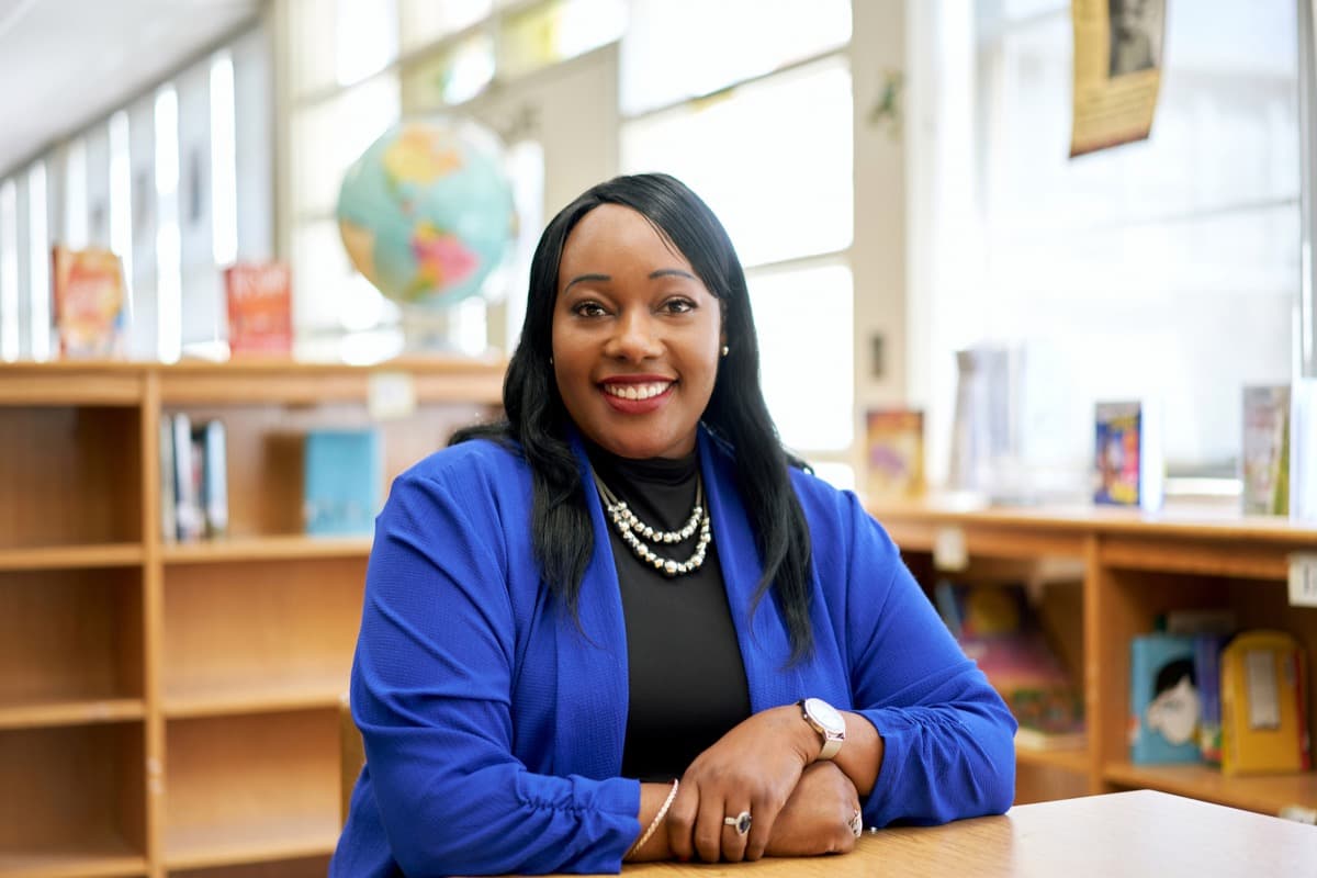 A confident educator smiling in a school library