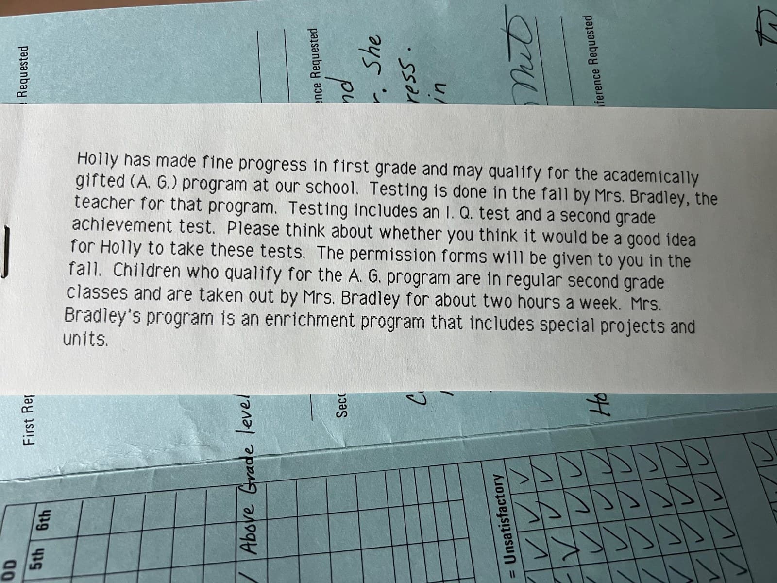 A first-grade school note saying Holly may qualify for the academically gifted program, tested by Mrs. Bradley