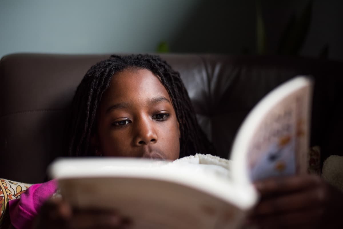 A young student absorbed in a book